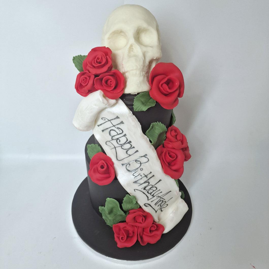 Black cake with a scull and red roses